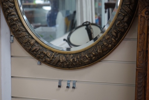 A gilt-framed oval mirror, width 66cm, height 78cm